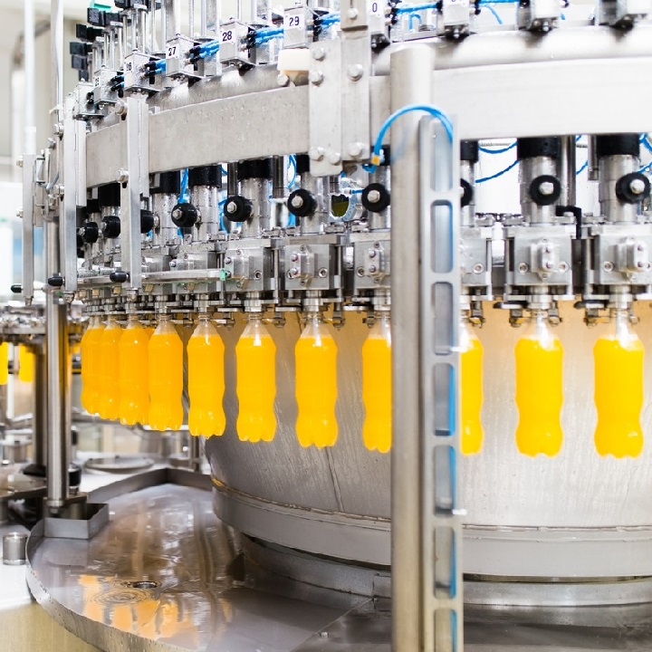 Water bottling line for processing and bottling orange carbonated juice into bottles.